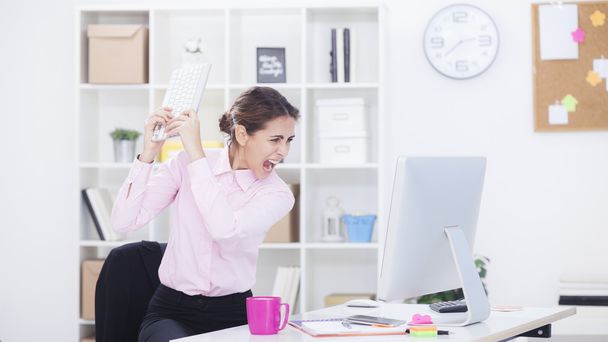 Stressed businesswoman working at desk  - Фото, изображение