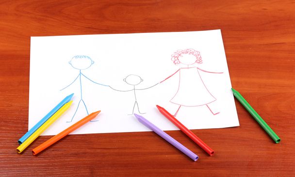 Childrens drawing of family and pencils on wooden background - Фото, зображення