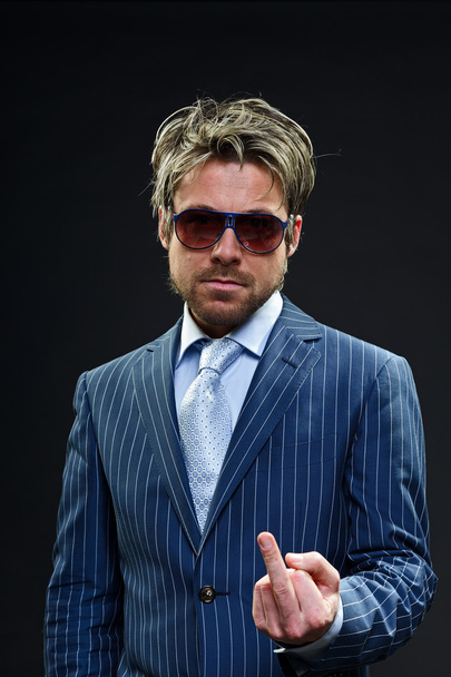 Stylish business man with short blond hair wearing blue striped suit and light blue tie. - Foto, imagen