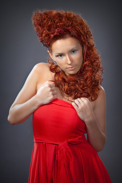 the girl with red hair in a red dress closeup - Foto, Imagen