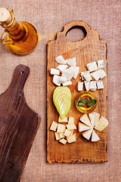 Cheese platter garnished on rustic wooden board - Photo, Image