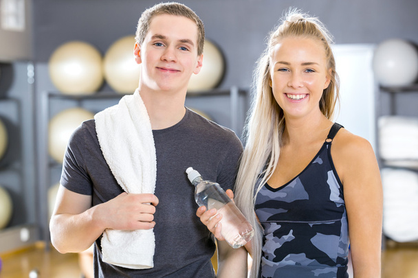 Portrait of two cheerful people having a break at gym - Photo, Image