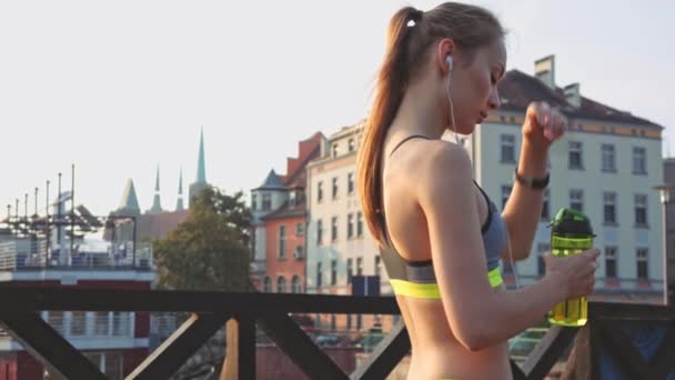 Runner woman drinking water and running - Video