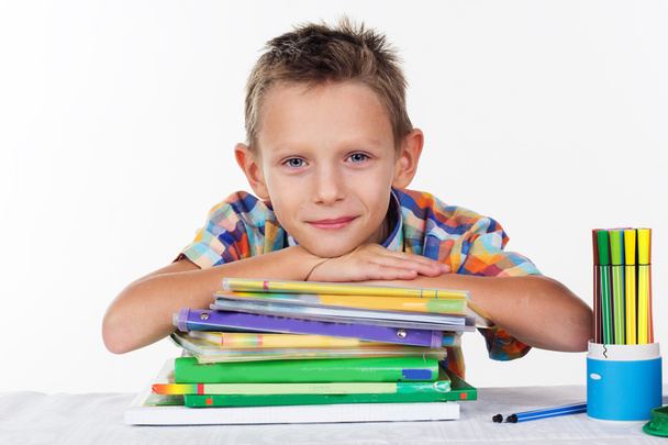Cute school boy with pile of colorful books - Foto, Imagen