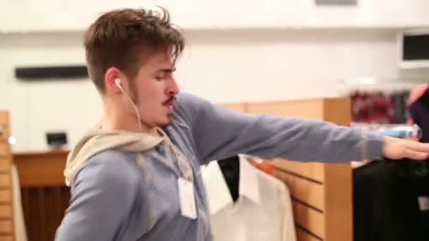 Young man dances near hangers  - Video