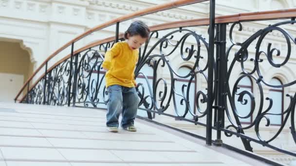Little handsome boy jumping - Materiał filmowy, wideo