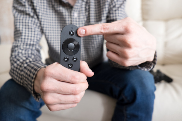 man is  holding remote controller - Foto, imagen