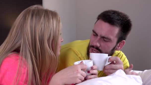 Young happy amorous couple with coffee or tea drink - Πλάνα, βίντεο