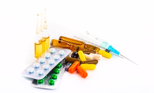 Various cold prescription bottles and a syringe isolated on a wh - Foto, Imagem