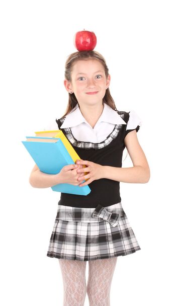 hermosa niña en uniforme escolar con libro y manzana aislada en blanco
 - Foto, Imagen