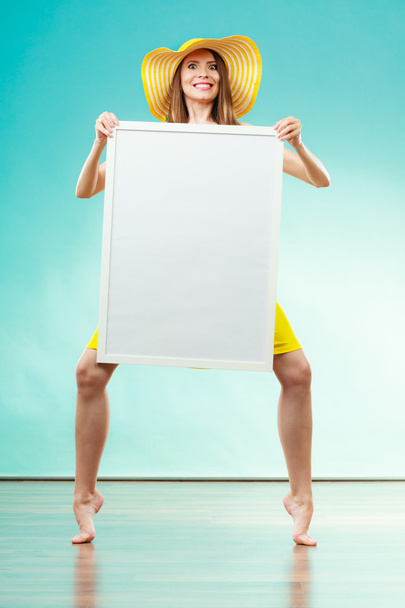 Woman in bikini holds blank presentation board. - Φωτογραφία, εικόνα