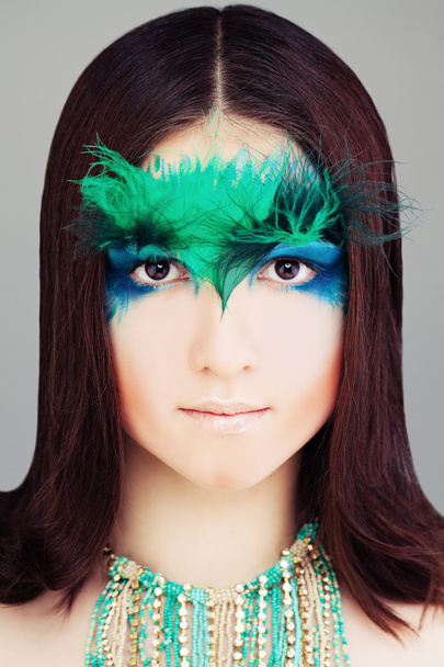 Yound Woman Fashion Model. Face with Makeup and Feather - Zdjęcie, obraz