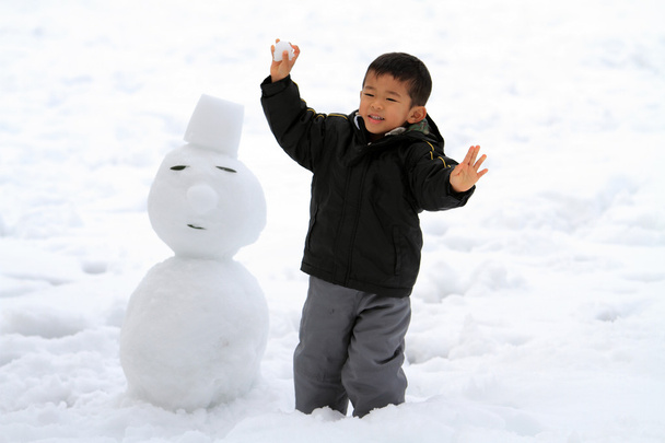 Japonés chico teniendo snowball lucha y snowman (4 años de edad
) - Foto, Imagen