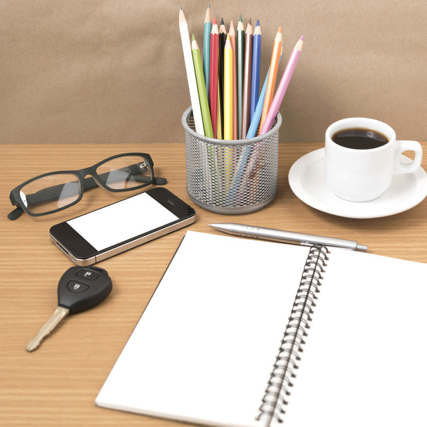 office desk : coffee and phone with key,eyeglasses,notepad,penci - Фото, зображення