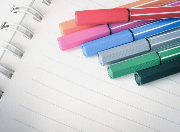 Colorful pens on notebook - Zdjęcie, obraz