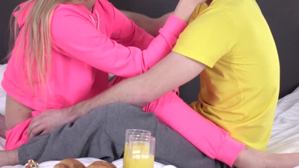 Beautiful young couple having breakfast in bed, cam moves upwards, closeup - Metraje, vídeo