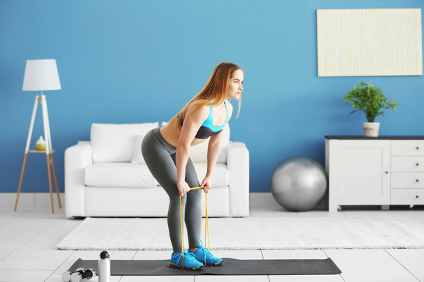 sportswoman doing exercises with rubber band - Fotografie, Obrázek