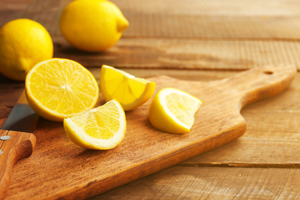 Sliced fresh lemons on wooden background - Fotó, kép