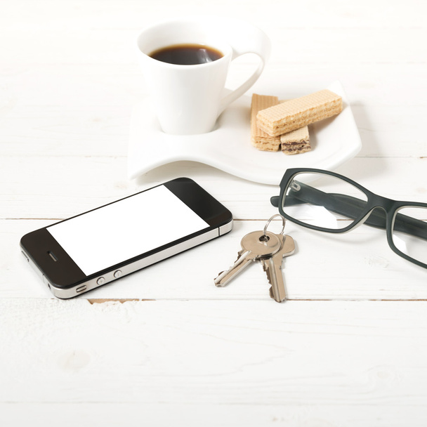 coffee cup with wafer,phone,key,eyeglasses - Foto, afbeelding