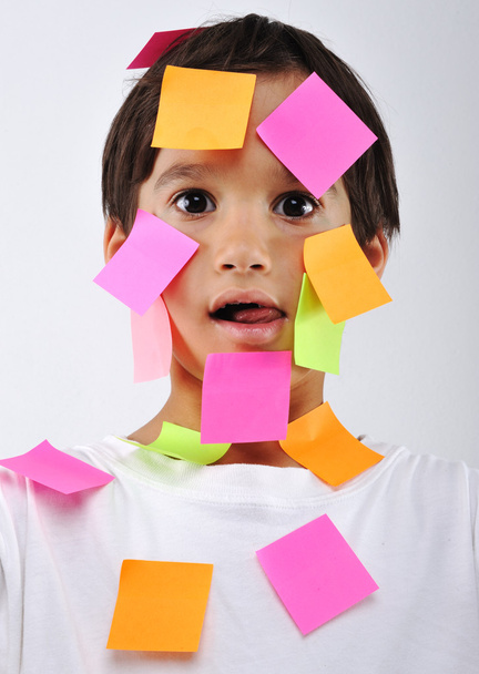 Little boy with memo notes on his face - Foto, imagen