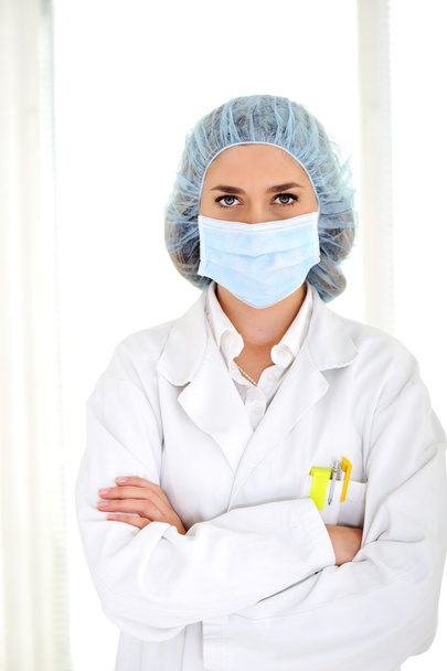 A female doctor wearing a mask at hospital - Фото, изображение