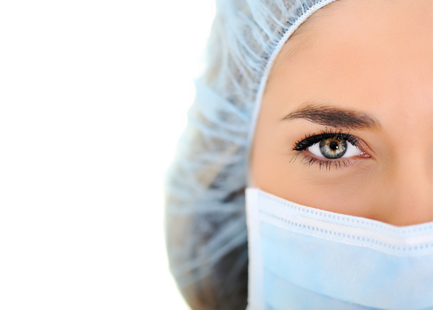 Female doctor wearing surgical cap and mask - Фото, изображение