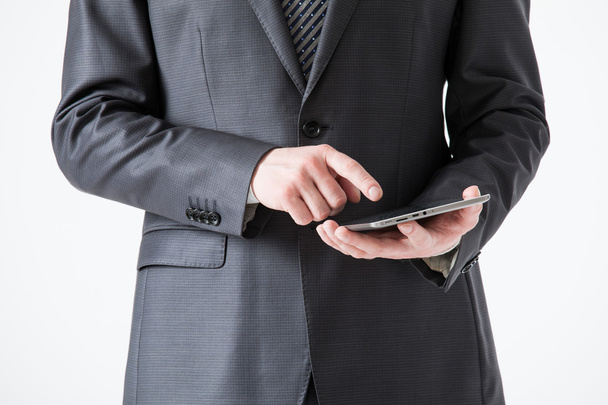 Businessman holding a pad - Фото, изображение