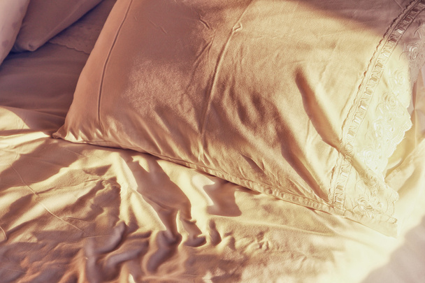 closeup photo of pillow and sheets at morning sunrise in the bedroom. vintage filtered - Valokuva, kuva