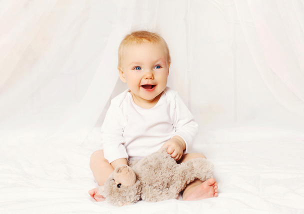 Happy smiling baby playing with on bed at home - Фото, зображення