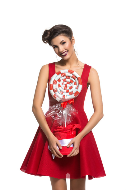 Girl in red dress with big candy - Фото, зображення