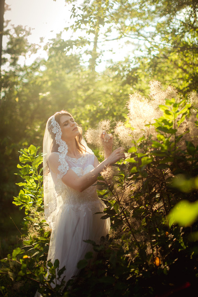 Bride in white dress in the garden - Fotó, kép