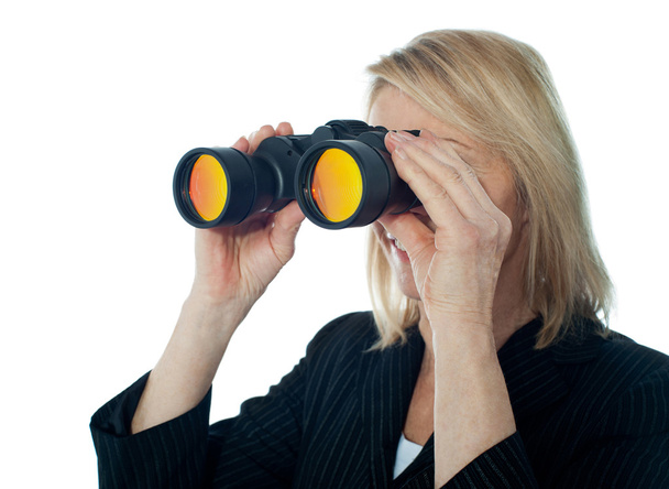 Female executive monitoring through binocular - Valokuva, kuva