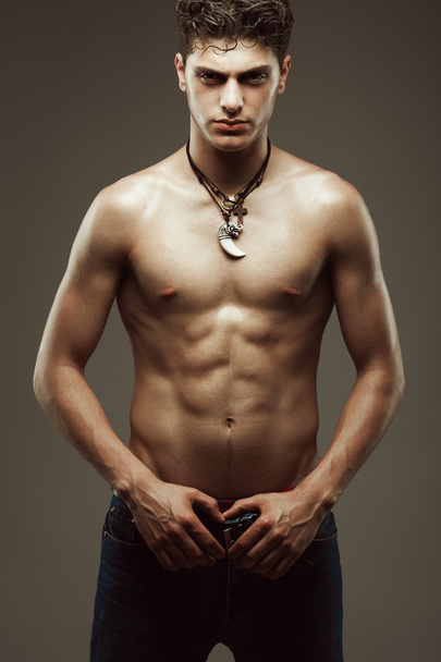 Male beauty & Blue jeans concept. Handsome muscular male model - Fotoğraf, Görsel
