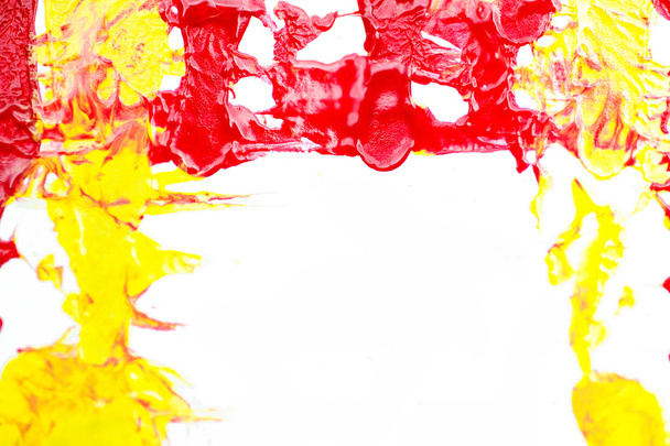 red and yellow paint on a white background - Фото, изображение