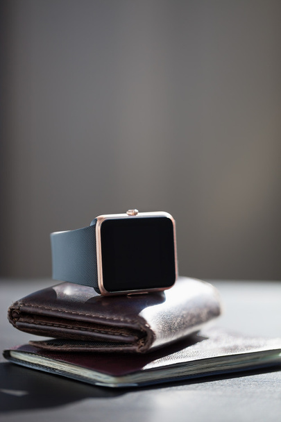 Smart watch, wallet with monet, passport on the table - Zdjęcie, obraz