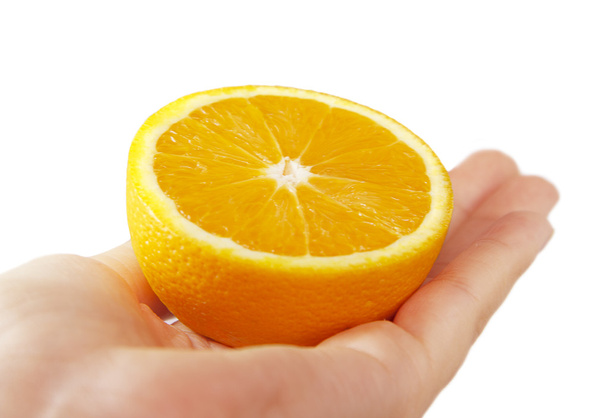 το ήμισυ του ένα πορτοκάλι στα χέρια - Φωτογραφία, εικόνα
