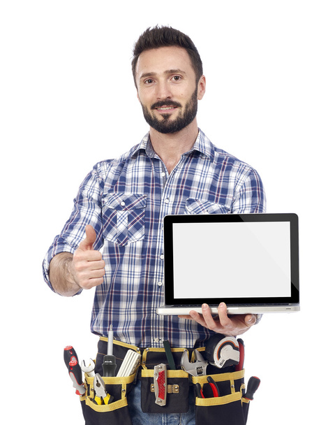 Confident handyman with laptop - 写真・画像