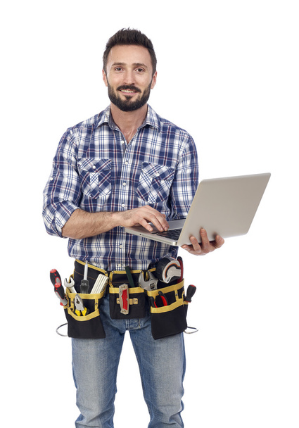 Confident handyman with laptop - Photo, Image