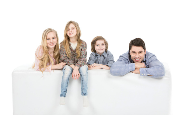 Happy family relaxing on sofa isolated on white. - Φωτογραφία, εικόνα