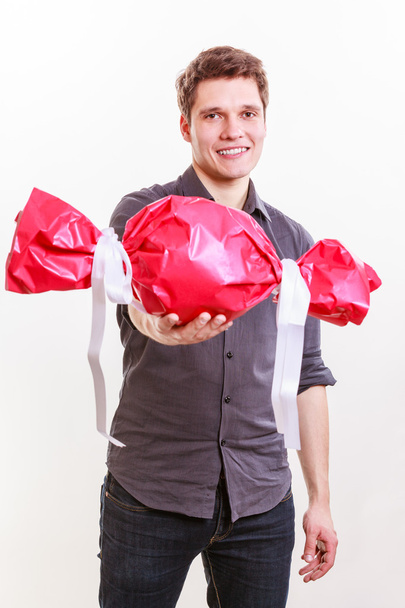 Man with big red candy. - Foto, imagen