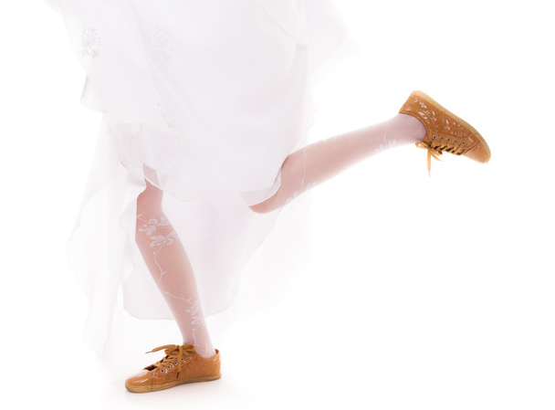 Wedding. Running bride woman legs in sport shoes - Fotografie, Obrázek