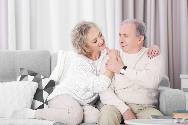 Happy mature couple sitting together - 写真・画像