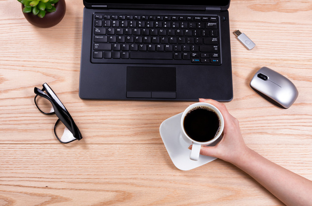 Büro-Desktop-Setup mit weiblicher Kaffeetasse in der Hand  - Foto, Bild