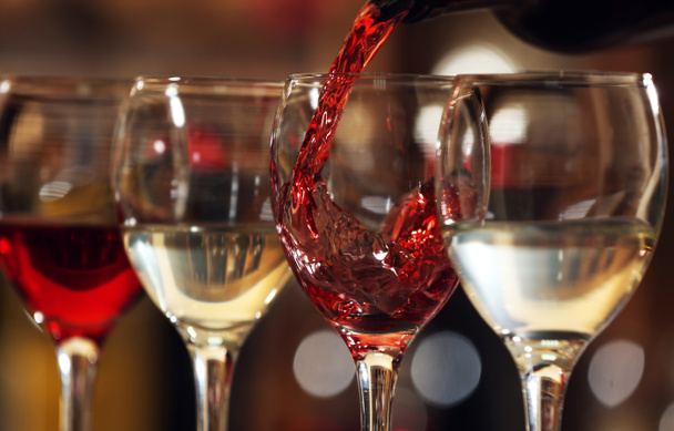 Red wine pouring into wine glass, closeup - Fotografie, Obrázek