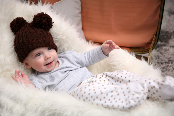 Adorable baby in brown knitted hat  - Fotoğraf, Görsel