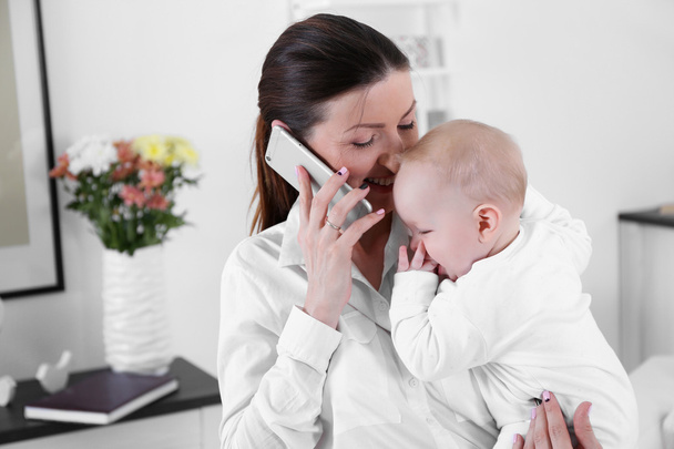 Businesswoman with baby boy - Foto, Bild