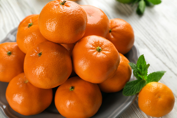 Pile of mandarin on light wooden background - Photo, Image