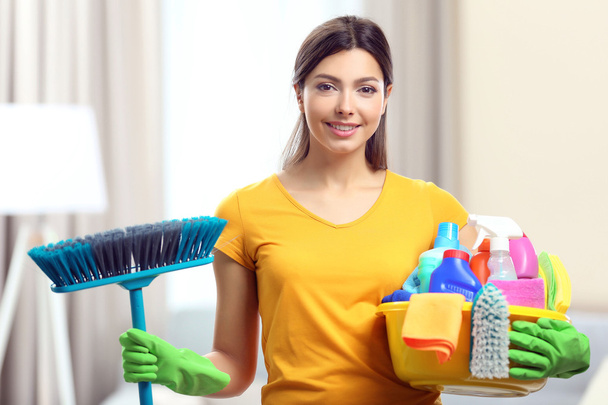 woman with basin of cleaning supplies - Φωτογραφία, εικόνα