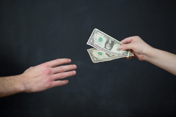 Concept - corruption. Giving a bribe. Money in hand - Fotografie, Obrázek