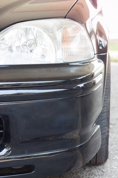 Closeup headlight of black coupe - Foto, afbeelding